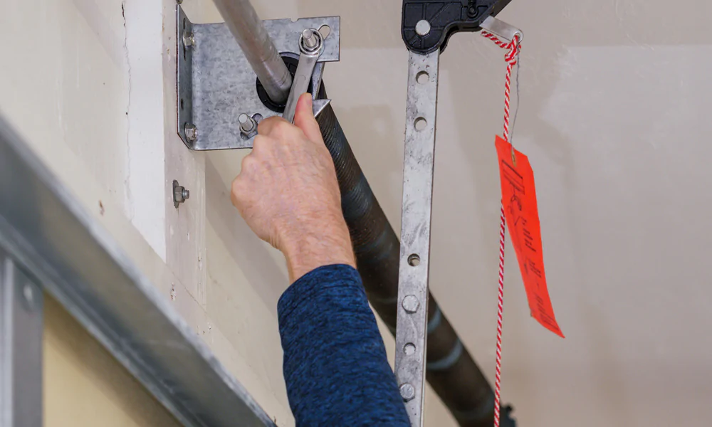 Ajustement des ressorts de torsion porte sectionnelle
